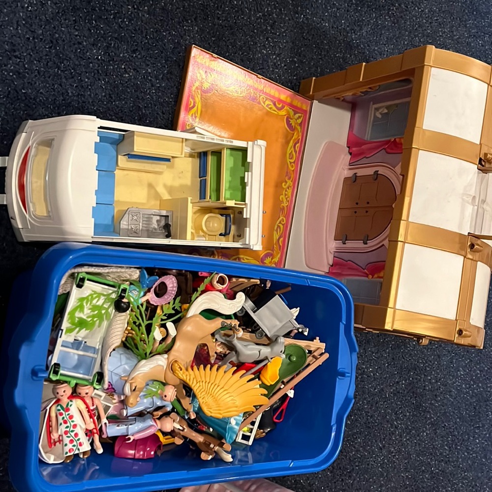 COPY - Playmobil figures and accessories, camper, and treasure chest/stage.